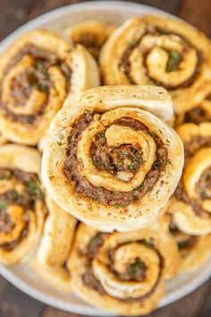 sausage biscuit pinwheels on a white plate with the title in the middle