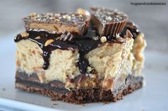 a piece of cheesecake with chocolate and nuts on top