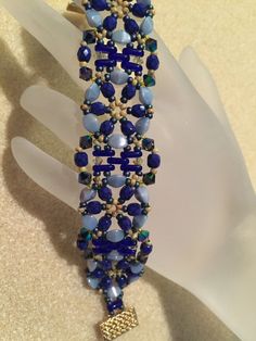 a blue and gold beaded bracelet on a mannequin's headdress