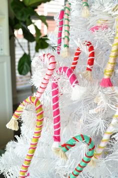 colorful candy canes are hanging on the christmas tree