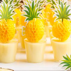 there are pineapples in small cups on the table