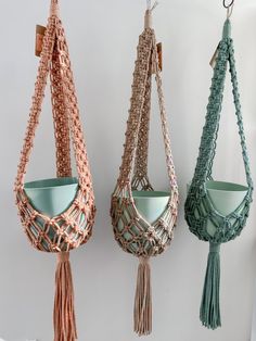 three macrame style hanging baskets with tassels in various colors and sizes