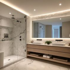 a bathroom with two sinks and a walk in shower