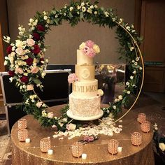 a wedding cake is surrounded by flowers and candles