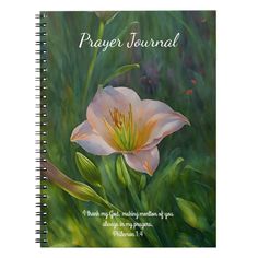 a spiral notebook with the words prayer journal written on it and a pink flower in the middle