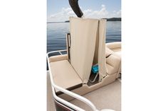 the back end of a boat with an open seat and storage bag on it's side