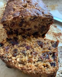 a loaf of fruit bread sitting on top of a piece of paper