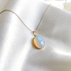 This stunning Pendant is set in 14k Solid Yellow Gold with Natural Ethiopion Opal with utmost precision. It is a unique gemstone Pendant for nearly every occasion and is completely hassle-free jewelry. ITEM DETAILS: * GEM: Ethiopion Opal * GEM SIZE: 12x16mm * GEM SHAPE: Oval * Gem weight: 6.39 carats * Gold Purity: 14KT (58.33% approx.) * Gold Weight: 1.16 gram * Total Weight of the Pendant: 2.44 gram The Gold purity is guaranteed and it comes with authentic 14KT gold hallmark. Since my items are handmade, they are absolutely nickel and lead free. CUSTOMIZATION: * Gemstone customization is available and it can be substituted with a gem of your choice. Kindly message me for the same. PACKAGING * The Pendant comes with layers of safe and secure wrapping along with Free handmade jewelry box w Elegant Ethiopian Opal Jewelry With Gemstone Accents, Fine Jewelry Wedding Necklace With Cabochon, Heirloom Opal Jewelry In Yellow Gold, Wedding Fine Jewelry Necklace With Cabochon, Heirloom Yellow Gold Opal Jewelry, Oval Opal Necklace For Wedding, Elegant Ethiopian Opal Jewelry With Cabochon, Elegant Ethiopian Opal Cabochon Jewelry, Elegant Ethiopian Opal Gemstone Jewelry