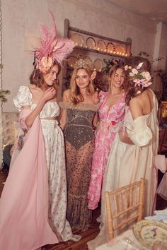 three women in dresses standing next to each other