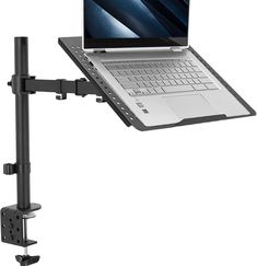 a laptop computer sitting on top of a desk with a monitor mounted to it's side