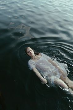 a woman floating on top of a body of water