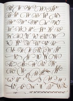 an open notebook with cursive writing on it, and the letters are all lined up