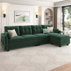 a large green couch sitting in a living room next to a window