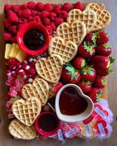 waffles, strawberries, and jelly are arranged on a platter