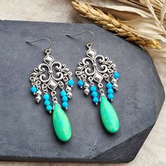 ∴ Boho Ethnic Earrings These earrings are made with beautiful silver coloured charms and blue and green beads. ∴ What you need to know » The earrings measure about 7.5 cm » See photos for a better idea of size If you like my shop but couldn't find exactly what you want, get in touch and we can come up with something together :) Handmade Chandelier Drop Earrings, Bohemian Turquoise Chandelier Drop Earrings, Handmade Turquoise Chandelier Earrings, Bohemian Turquoise Drop Beaded Earrings, Bohemian Turquoise Beaded Drop Earrings, Elegant Handmade Turquoise Earrings, Bohemian Green Drop Earrings, Green Bohemian Drop Earrings, Elegant Handmade Turquoise Chandelier Earrings