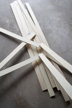 several pieces of wood are laying on the floor with one piece cut out to look like an x