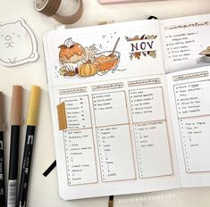 an open planner with pumpkins on it next to some markers and pencils,