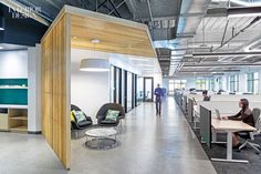 an office with people working at desks in the background and open space on the other side