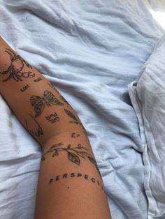 a person laying in bed with tattoos on their arm and leg, reading the word respect