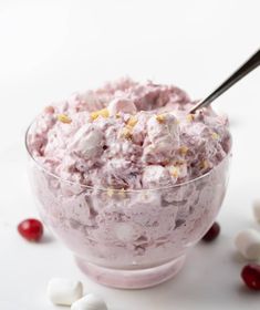 a bowl filled with ice cream surrounded by marshmallows and cranberries