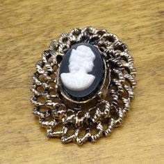 "Vintage Black and White Cameo Brooch, Elegant Victorian Style in Gold Tone Double Frame Measurement * 1-1/2\" x 1-1/4\" unmarked Condition * Very nice condition. Gently used. Size: Womens OS Condition: Pre-Owned Good" Antique Black Brooch For Wedding, Vintage Black Collectible Brooches, Antique Black Wedding Brooch, Antique Black Wedding Brooches, Vintage Black Lapel Pin As Gift, Vintage Black Lapel Pin For Gift, Black Vintage Lapel Pin For Gift, Vintage Black Brooch Lapel Pin, Victorian Black Cameo Brooches