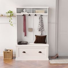 a white wooden bench sitting next to a shelf filled with coats and shoes on top of it