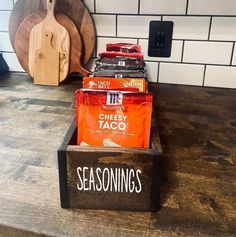 a wooden box filled with taco sitting on top of a counter