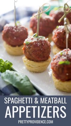 spaghetti and meatball appetizers are on a plate