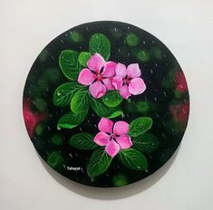 a painting of pink flowers with green leaves on a black circle surface, painted in acrylic paint