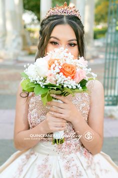 a young woman wearing a tiara holding a bouquet of flowers