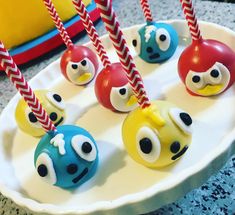 some angry birds are on a plate with red and blue straws in it's eyes