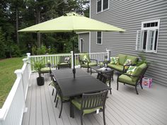 a deck with chairs and an umbrella on it