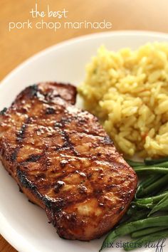 a plate with meat, rice and green beans on it that says the best pork chop marinade