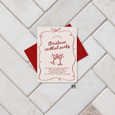 a red and white christmas cocktail party card sitting on top of a tile floor next to a red envelope