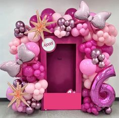 a pink and silver balloon frame with balloons on the front, stars in the back