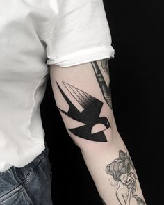 a person with a bird tattoo on their arm