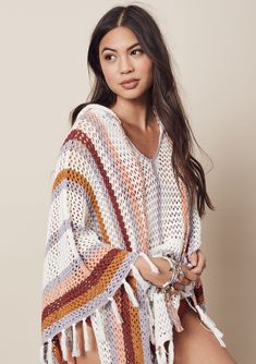 Throw it back to the 70s in our oversize multicolor stripe crochet poncho! Featuring a boho fringed hem, breezy open-knit, and kangaroo style pocket. Throw it on over your swimsuit for a quick cover-up at the beach or poolside! FINAL SALE Oversize fit Mid-length V-neckline Hooded Kangaroo front pocket Model is 5'7, garment is O/S.Style: I-50365 Bohemian Knit Poncho With Fringe, Casual Poncho For Beach Cover-up In Fall, Bohemian Knitted Poncho For Spring, Bohemian Knitted Poncho For Fall, Bohemian Open Knit Beach Poncho, Bohemian Open Knit Poncho For Beach, Bohemian Open Knit Poncho One Size, One Size Bohemian Open Knit Poncho, Casual Fall Beach Poncho