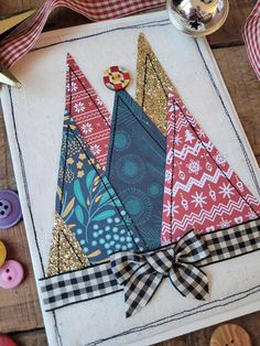 a close up of a piece of cloth on a table with buttons and other items