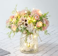 PRICES MAY VARY. PACKAGE - Including LED lights, 3 aritficial Rose Bouquets and a Glass Vase. Total height is about 13”/33CM. Vase height is 6.3"/16CM. Flower height is about 13”/33CM. CREATIVE LED DECORATION - This Table LED flowers is perfect for your wedding, party, baby shower or home decor, etc. EASY TO SET UP- Put half of the led lights in the vase, and wrap the rest around the fake flowers. The LED lights have 8 remote control mode. LIGHT UP YOUR LIFE - The entire flowers and vase are dec Artificial Flower Arrangements Centerpieces, Daisy Wedding Theme, Wedding Table Centerpieces Elegant, Fake Flower Centerpieces, Simple Floral Centerpieces, Pastel Wedding Decorations, Pink Flower Arrangements, Tissue Paper Flowers Diy, Centerpiece Home