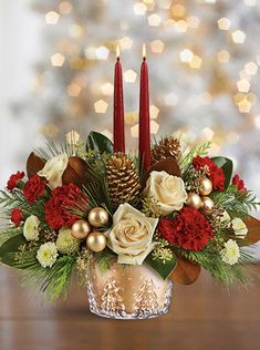 a christmas centerpiece with candles and flowers