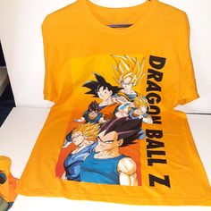 Dragon Ball Z Shirt Xl,Brand New With Tags Yellow T-shirt With Character Print, Yellow Graphic Tee With Character Print, Yellow Short Sleeve Top With Character Print, Yellow Graphic Tee With Screen Print, Yellow Graphic Tee Shirt With Screen Print, Yellow Graphic Tee With Crew Neck, Yellow Graphic Print Graphic Tee Shirt, Yellow Cotton Tops With Character Print, Yellow Short Sleeve Streetwear Shirt