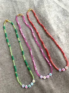 Design your perfect necklace ✨ These beaded necklaces are fully customized. I can make it in two colors like in the picture, one, or rainbow, you pick!  If you want two of more colors please let us know in the personalization box!  Let me know which name, word or initials you want to put on it as well as the Letters color🤍 in the personalization box  Letters can be: Black, Purple, Pink, Green, Orange, Yellow or Blue Cute Jewelry With Round Letter Beads, Casual Beaded Necklaces With Letter Beads As A Gift, Casual Beaded Necklace With Letter Beads For Gift, Trendy Adjustable Beaded Necklace, Cute Letter Beads Necklaces For Friendship, Cute Beaded Necklace With Letter Beads For Gift, Cute Beaded Necklaces With Letter Beads For Gift, Cute Letter Beads Beaded Necklace As Gift, Cute Beaded Necklaces With Tiny Beads For Gifts