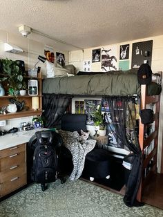 there is a bunk bed in the room with many things on the shelves and floor