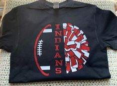 a black t - shirt with the word indians on it and a football in the center