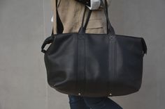 This handmade black color strong genuine leather weekender bag is a perfect for taking away for the weekend or as hand luggage for a holiday. Simple, classic, and ready to go with you.  It can be customized gift for your girlfriend - boyfriend, mom - dad, wife - husband, teacher, boss, daughter, best friend, or any other person. This bag is minimalist, simple, reliable, and durable. Features: ▸ 100 % calfskin ▸ Cotton lining with 2 pockets ▸ Metal zipper closure ▸ Dimensions by Inches: L17.7 x H Mens Duffel Bag, Hand Luggage Bag, Women Vacation, Overnight Travel Bag, Leather Weekender Bag, Leather Weekender, Black Travel, Hand Luggage, Luggage Bag