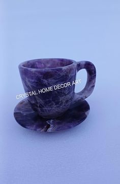 a purple marble cup and saucer with the words crystal home decor art on it