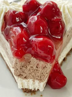 a piece of cheesecake with cherries on top