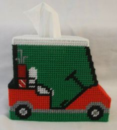 a tissue dispenser with a green and red truck on it