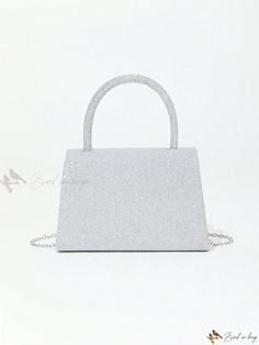 a white purse with a chain on the front and side, sitting against a white background