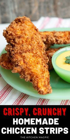 crispy, crunchy homemade chicken strips on a green plate with a small bowl of dip